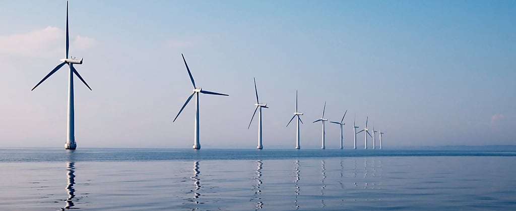 Row of wind turbines in sea, calm water